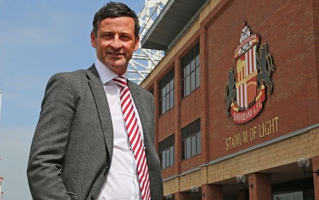Jack Ross stands outside Sunderland AFC's stadium